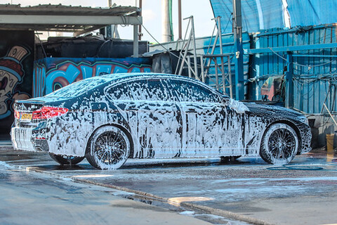 A car covered in soapy water, about to be waxed.