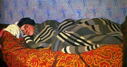 A woman sleeping on a bed.