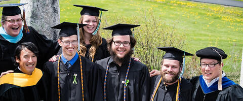 A group of graduating seniors pose for a photo.