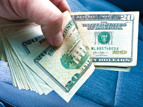 A person holding a bunch of money.