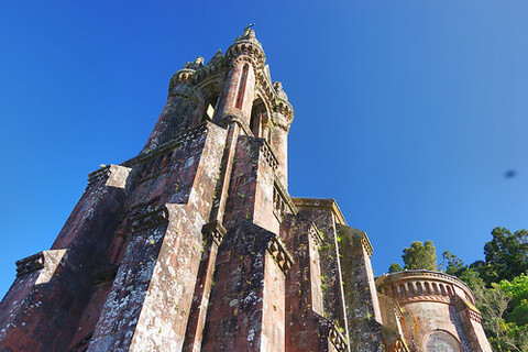 An old, brown and white tower with a weathered appearance, possibly part of a castle.