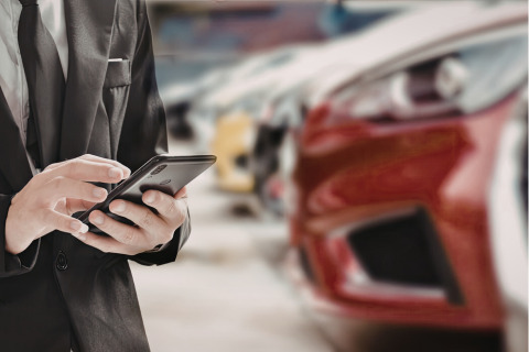 A man consulting some used cars.