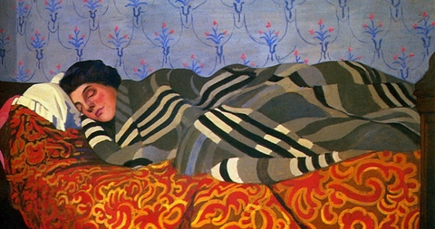 A woman sleeping on a bed.
