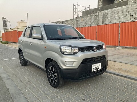 A gray SUV parked on a street.