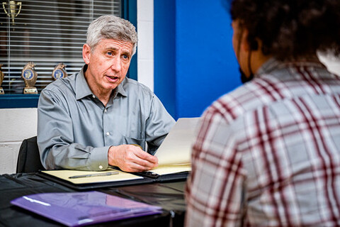 A man interviewing for a job with another man